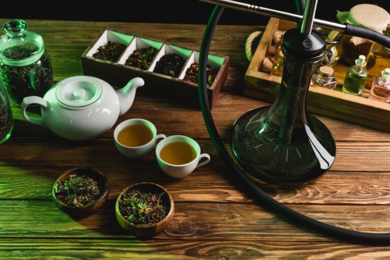top-view-of-teapot-dry-tea-and-hookah-on-wooden-su-Q8Z6SBG.jpg